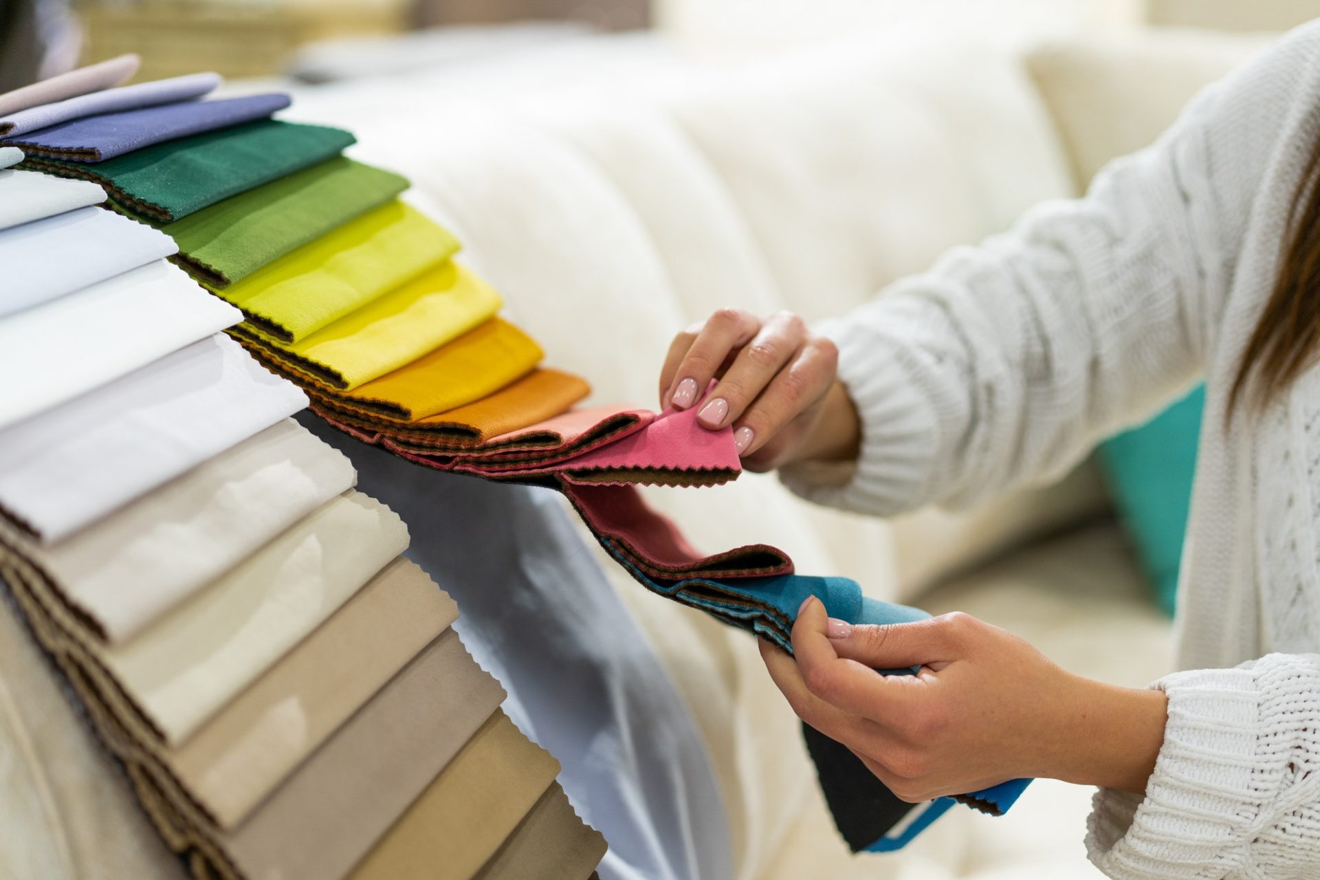 the-woman-chooses-the-fabric-on-the-sofa-textile-industry-background-tissue-catalog-e1627088629379 the-woman-chooses-the-fabric-on-the-sofa-textile-industry-background-tissue-catalog-e1627088629379